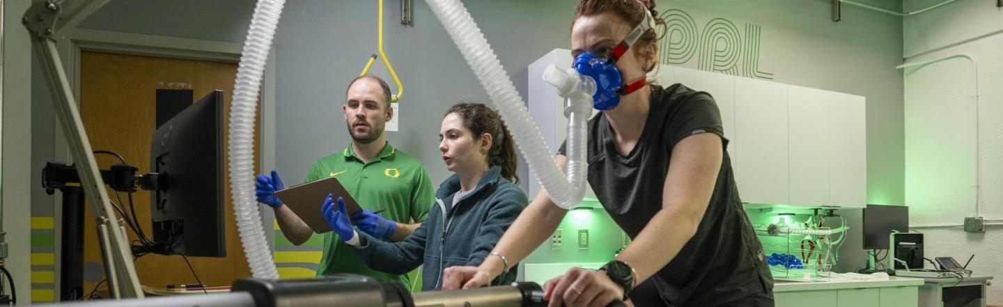 researchers studying person on stationary bike