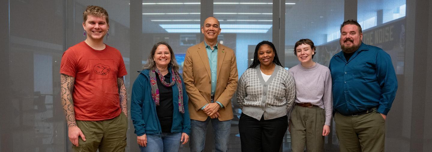 Six UO employees smile for group photo