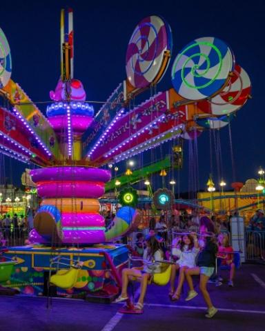 Colorful ride at the Lane County Fair illuminated at night