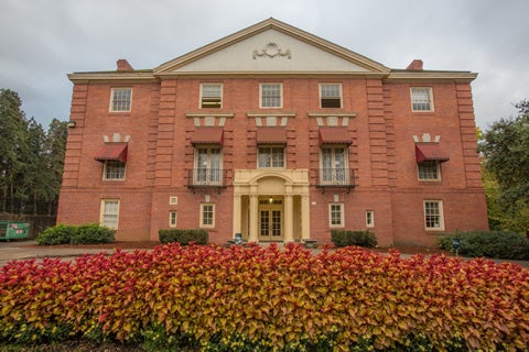 Building on campus with flowers in the foreground